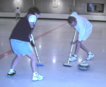 Brushing action on curling ice