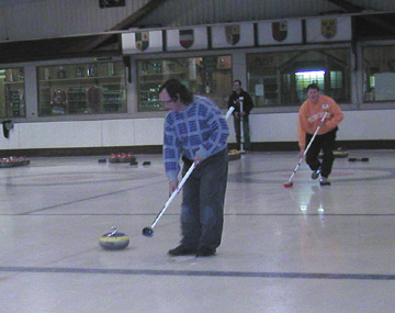 Preparing to sweep in curling