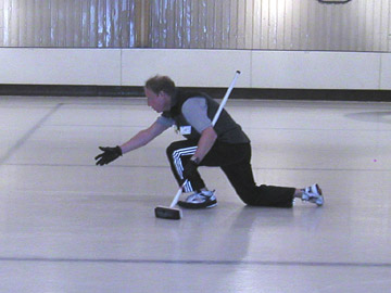 Tony releasing a curling stone