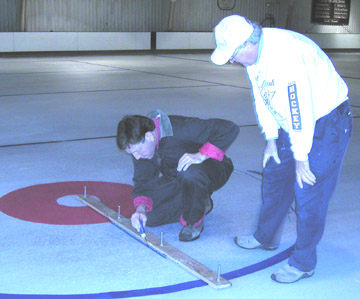 Larry LaBorde and Eddie Shipstad measuring curling ice
