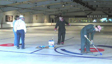 Painting the ice for curling